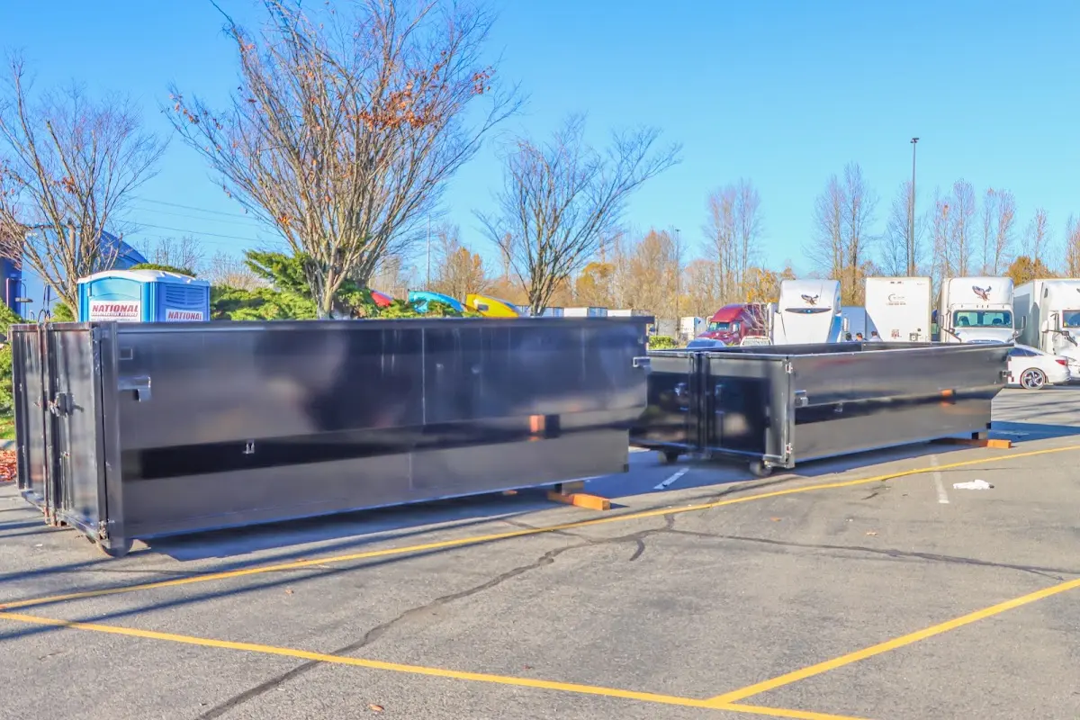 Professional dumpster rental service with roll-off container on residential driveway in Green Lake